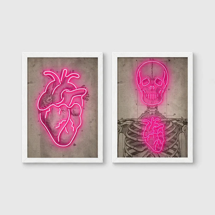 Set of 2 framed prints, neon anatomical illustrations: a neon pink anatomical heart illustration; and a neon pink skeleton skull and ribcage illustration — unframed